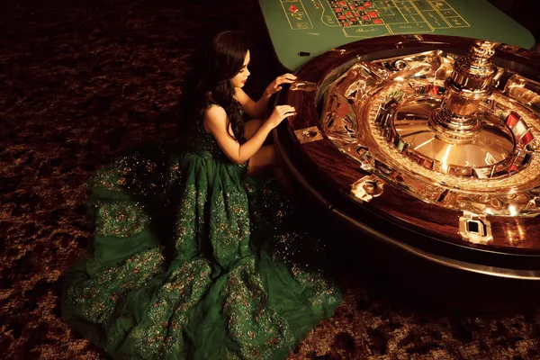 A glamorous woman holding casino chips in a neon-lit environment, representing the premium online casino atmosphere of 7555BET.